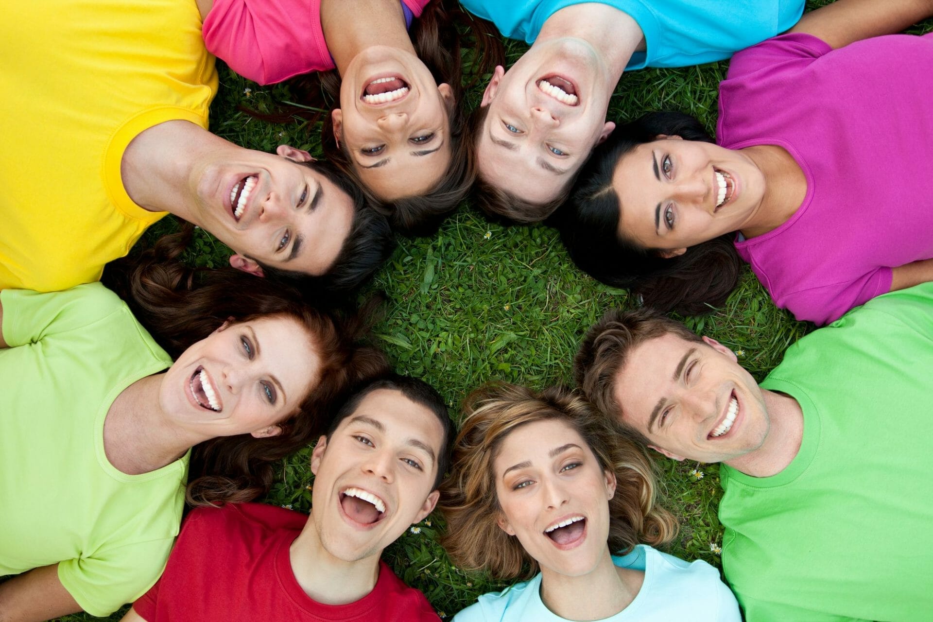 A group of young people enjoying their time together on the grass in Sugar Land.