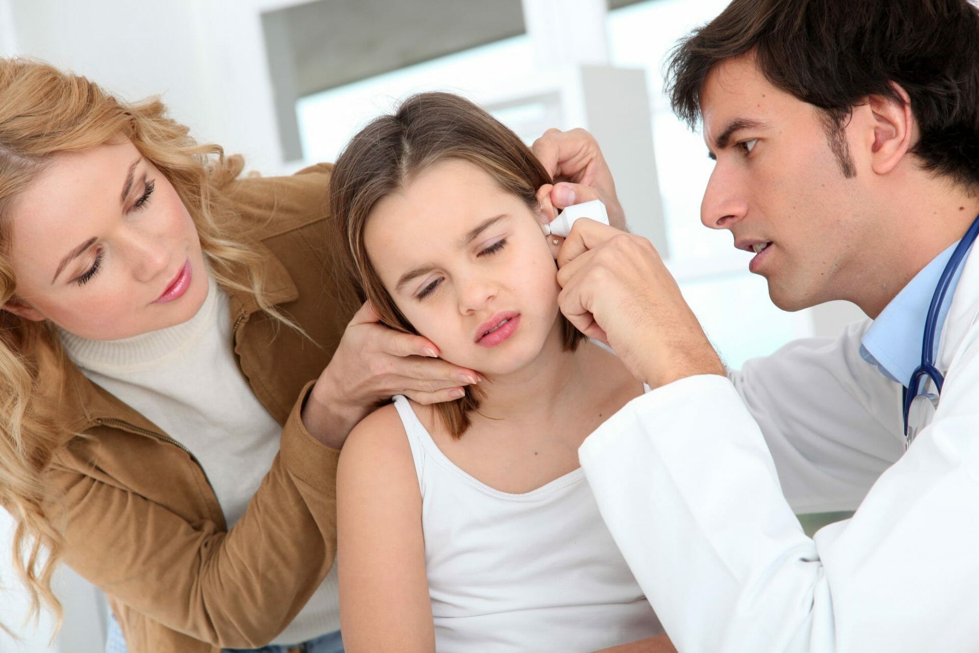 A pediatrician in Sugar Land is examining a child's ear.
