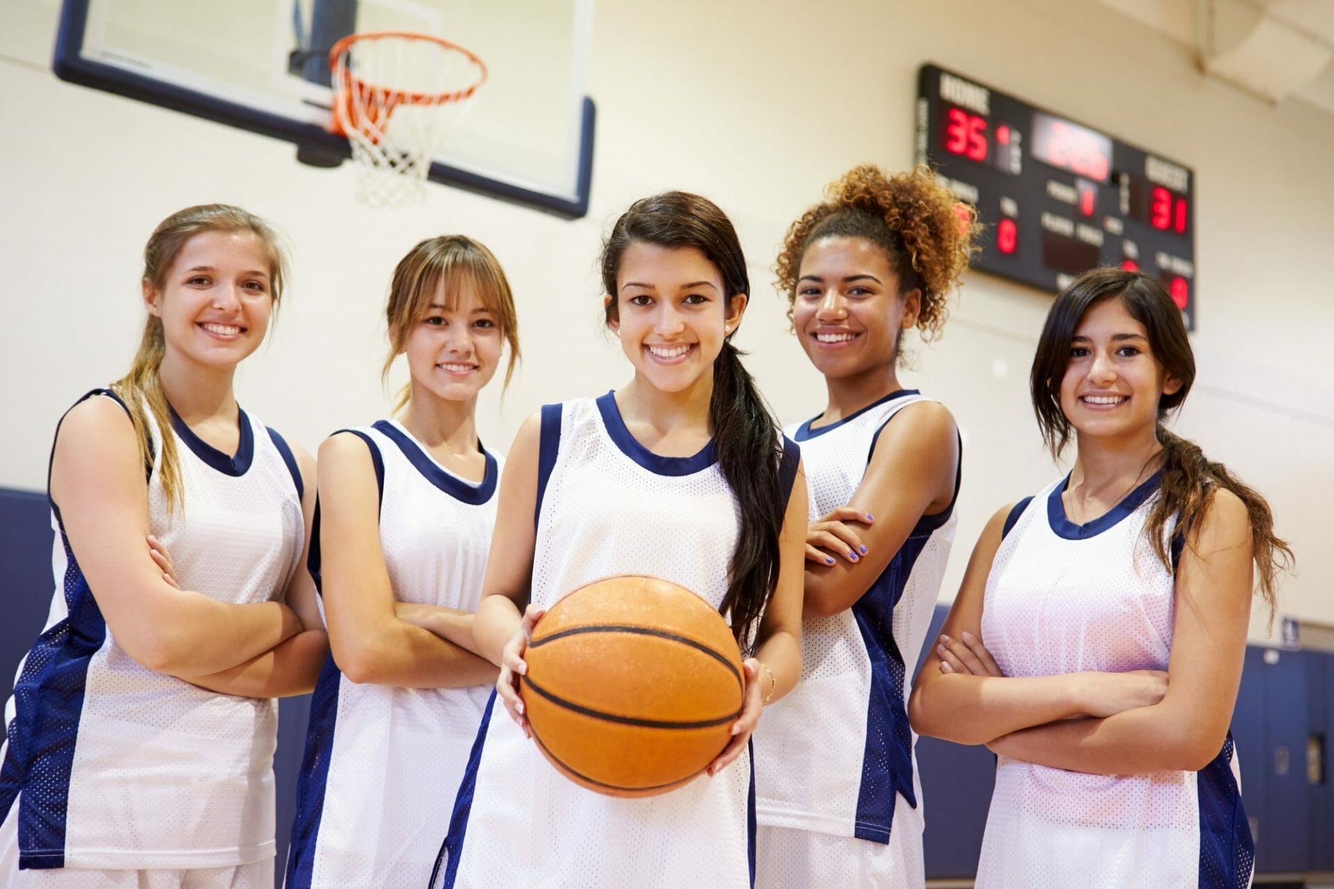 A group of female basketball players posing for a photo.